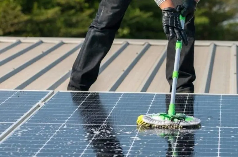 solar panel cleaning company in Everett technician using soft brush method on rooftop panels